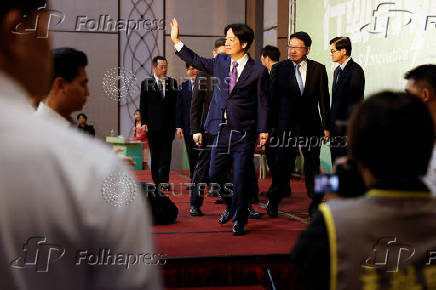 Taiwan President-elect Lai Ching-te speaks waves during a press conference in Taipei