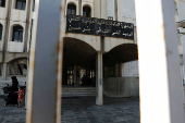 An internally displaced woman and girl walk at the Technical Institute of Bir Hassan, which has been turned into a shelter, in Beirut