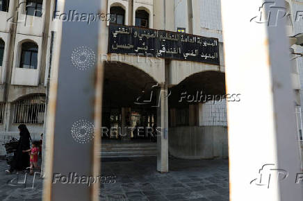 An internally displaced woman and girl walk at the Technical Institute of Bir Hassan, which has been turned into a shelter, in Beirut