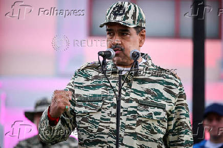 Members of the Bolivarian Militia and supporters of President Nicolas Maduro march to plead allegiance