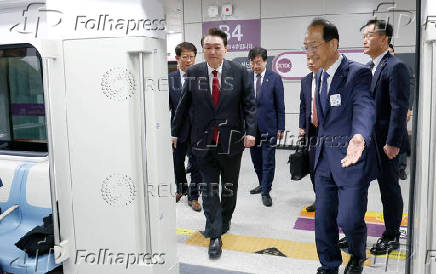 South Korean President Yoon Suk Yeol gets on a train after an opening ceremony of GTX-A in Seoul