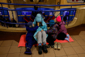 People take shelter inside a metro station during a Russian military strike, in Kyiv