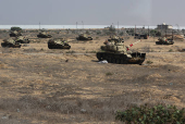 Military vehicles are seen on the road to the Rafah border amid the ongoing conflict between Israel and Hamas, in Rafah