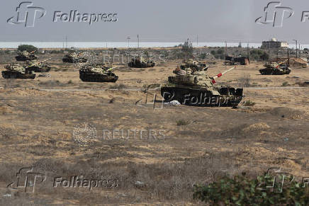 Military vehicles are seen on the road to the Rafah border amid the ongoing conflict between Israel and Hamas, in Rafah