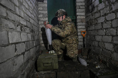 Policeman of the 'Khyzhak' Brigade prepares mortar shells before firing towards Russian troops at their position in a front line near the town of Toretsk