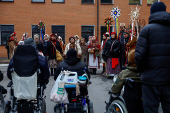 People dressed in traditional clothes sing carols for injured service members in Kyiv