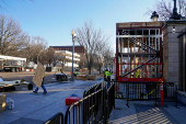 Construction workers finish up the inagural reviewing stand