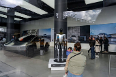 People look at a Tesla Cybertruck and a Tesla Bot at a Tesla showroom in New York City