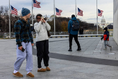 People visit the Washington Monument on a cold day in Washington, D.C.