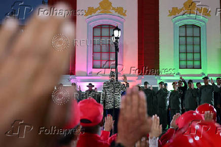 Members of the Bolivarian Militia and supporters of President Nicolas Maduro march to plead allegiance