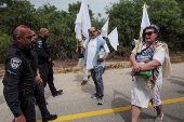 Israeli police stand by as protestors take part in a demonstration by Israeli and American Rabbis as they gather to symbolically bring food to Gaza, near Erez crossing