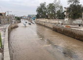 Vehicles drive on flooded road following rains in Sanaa