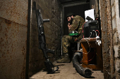 Policeman of the 'Khyzhak' Brigade sits inside a dugout at a position in a front line near the town of Toretsk