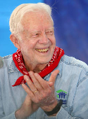 FILE PHOTO: Former U.S. President Carter applauds after building completion of a house in Chiang Mai