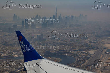 An aerial view of the Dubai skyline including the Burj Khalifa Tower as seen from an airplane