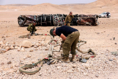 The evacuation of apparent remains of a ballistic missile from the location it was found lying in the desert, following a massive missile and drone attack by Iran on Israel