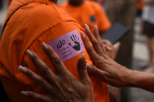 Demonstrators attend a walk, aimed to call for an end of violence against girls and women, in Copacabana beach in Rio de Janeiro