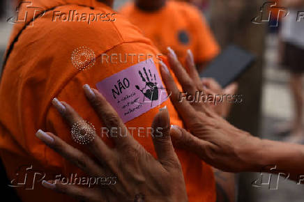 Demonstrators attend a walk, aimed to call for an end of violence against girls and women, in Copacabana beach in Rio de Janeiro