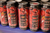 Cans of Hell Energy Drink are displayed on a shelf in a supermarket