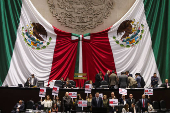 Congress members oppose a reform during a session, in Mexico City