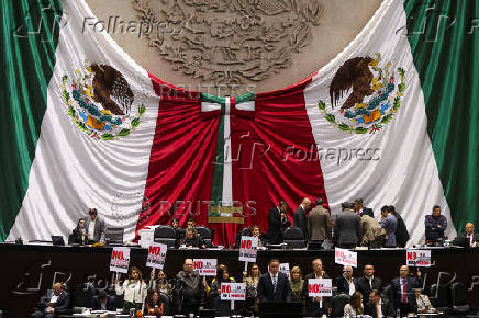 Congress members oppose a reform during a session, in Mexico City