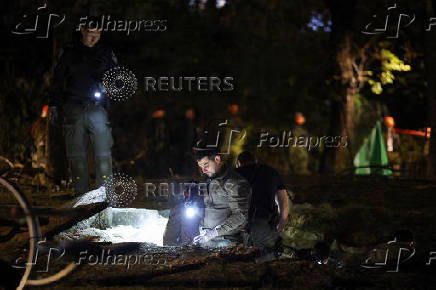 Israeli emergency services work at the scene of a missile strike, in Jaffa, south of Tel Aviv