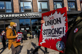 Workers picket in front of a Starbucks in the Brooklyn borough in New York