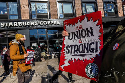 Workers picket in front of a Starbucks in the Brooklyn borough in New York