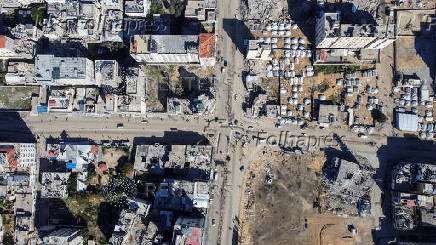 A drone view shows damaged and destroyed buildings as displaced Palestinians shelter in tents, following a ceasefire between Israel and Hamas, in Gaza City