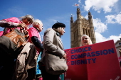 Campaigners for and against assisted dying gather during a debate in Parliament