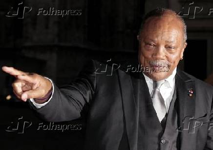 Jones poses for photographers as he arrives for the dinner after the ballet 