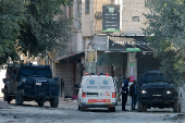 Palestinian security forces patrol amid clashes with militants at the camp in Jenin