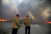 Firefighters and aircraft battle the Hughes Fire near Santa Clarita