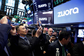FILE PHOTO: Founder and CEO of Zuora, Tien Tzuo, takes part in the company's IPO on the floor of the New York Stock Exchange shortly after the opening bell in New York