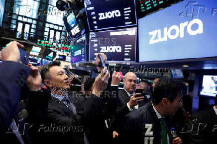 FILE PHOTO: Founder and CEO of Zuora, Tien Tzuo, takes part in the company's IPO on the floor of the New York Stock Exchange shortly after the opening bell in New York