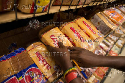 FILE PHOTO: An employe holds loaves of bread at a supermarket in Nairobi