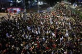 People attend a protest calling for the immediate release of hostages, in Tel Aviv