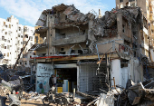 Men stand outside a mobile shop in the Chiyah district of Beirut's southern suburbs