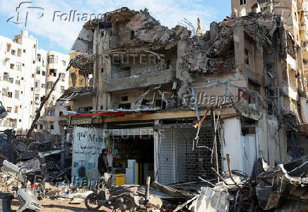 Men stand outside a mobile shop in the Chiyah district of Beirut's southern suburbs