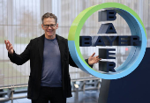 Bill Anderson, CEO of Germany's drug maker Bayer AG poses for a portrait session next to the company?s logo at the Bayer headquarters in Leverkusen