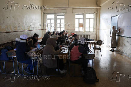 Students in a classroom after authorities announced the reopening of schools, in Damascus