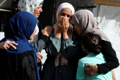 Mourners react during the funeral of Palestinians killed in Israeli strikes, amid the ongoing conflict between Israel and Hamas, at Al-Aqsa hospital, in Deir Al-Balah, in the central Gaza Strip