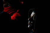 Migrants wait to disembark from a Spanish coast guard vessel, in the port of Arguineguin, on the island of Gran Canaria