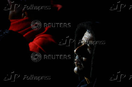 Migrants wait to disembark from a Spanish coast guard vessel, in the port of Arguineguin, on the island of Gran Canaria