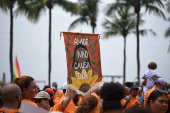 Demonstrators attend a walk, aimed to call for an end of violence against girls and women, in Copacabana beach in Rio de Janeiro