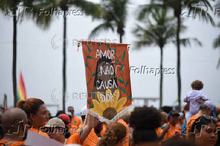 Demonstrators attend a walk, aimed to call for an end of violence against girls and women, in Copacabana beach in Rio de Janeiro