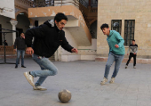 Students in a classroom after authorities announced the reopening of schools, in Damascus