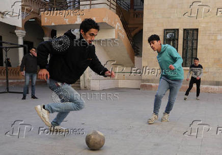 Students in a classroom after authorities announced the reopening of schools, in Damascus