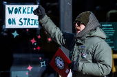 Workers picket in front of a Starbucks in the Brooklyn borough in New York