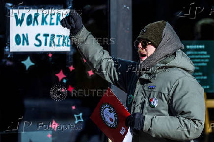 Workers picket in front of a Starbucks in the Brooklyn borough in New York